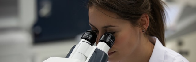 Female scientist looking in a microscope