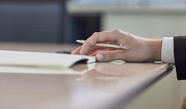 Businessman holding a pen and paper