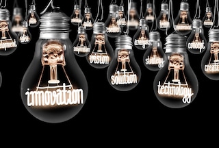 Lightbulbs with illuminated words inside them: technology, innovation, vision, etc.