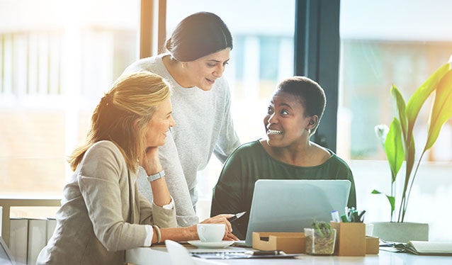 Three women talking in an office