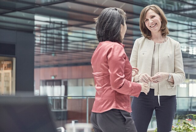 Moira Gilchrist, VP Strategic & Scientific Communications talking with a colleague