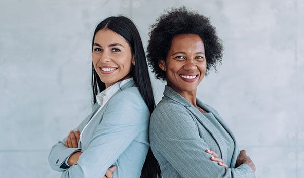 Two businesswomen smiling