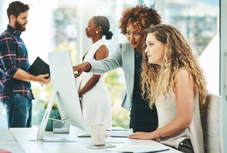 Female employee and her mentor in the office