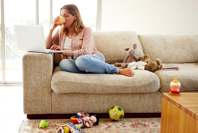 Mother working on laptop from home