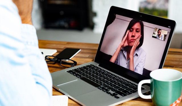 Woman looking unhappy on business video call