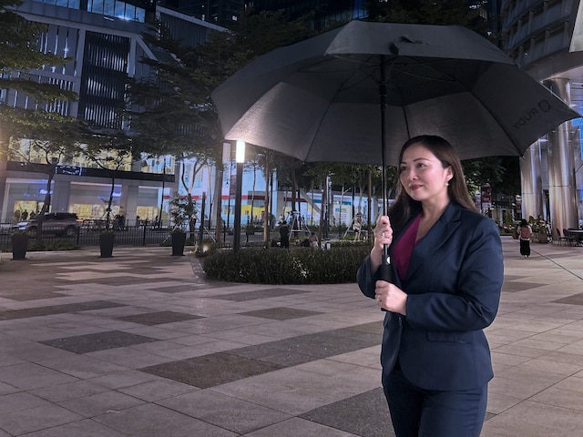 Woman with umbrella at night
