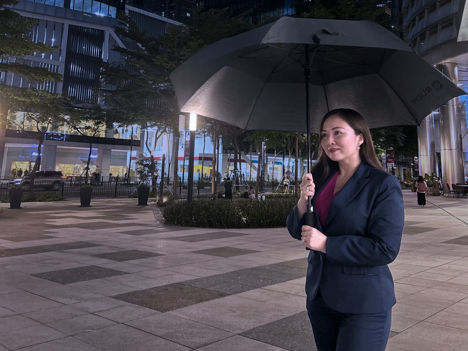 Woman with umbrella at night