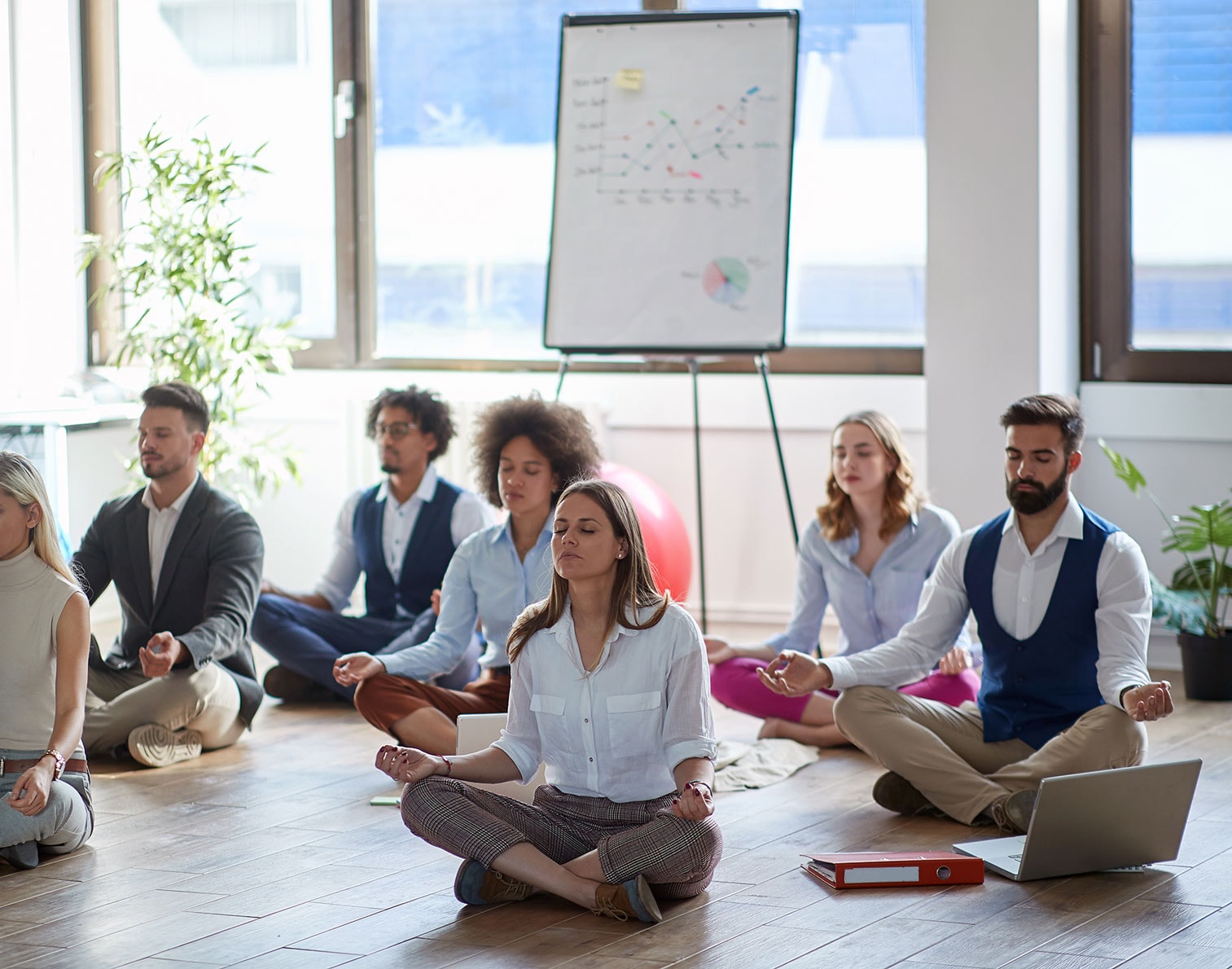 Workers meditating in the office