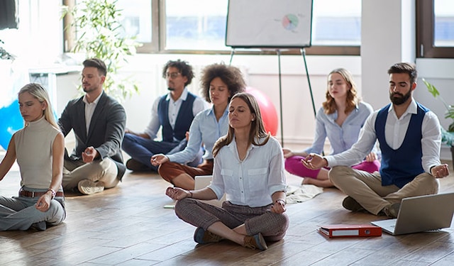 workers meditating in the office