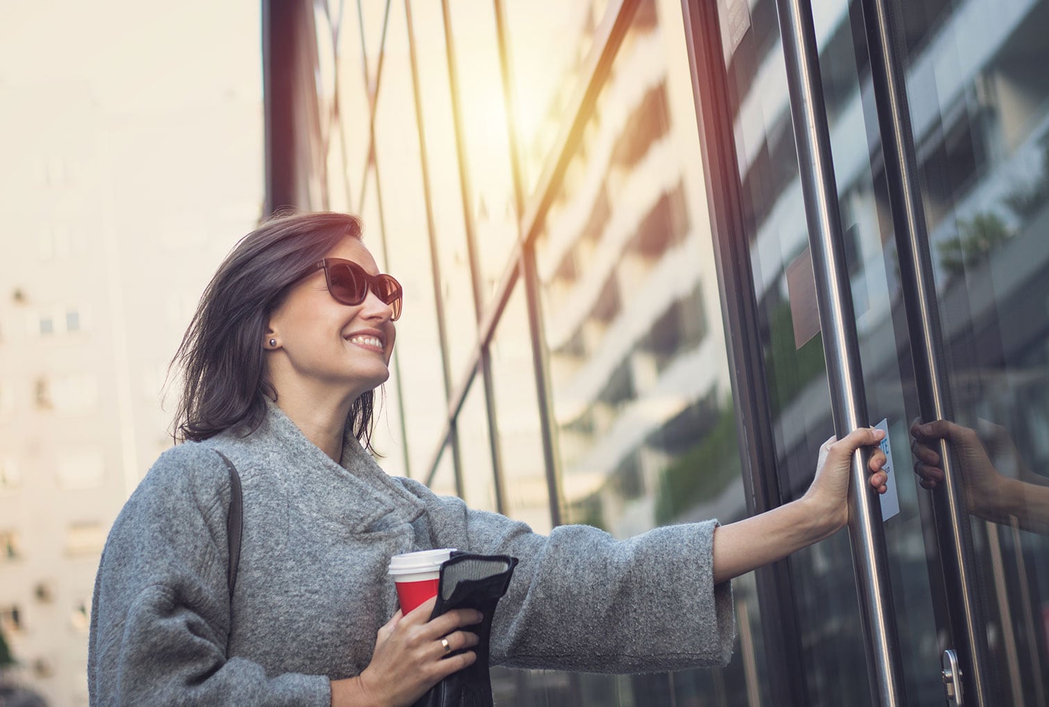 Smiling woman entering an office building