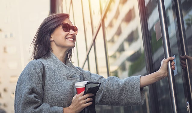 Smiling woman entering an office building